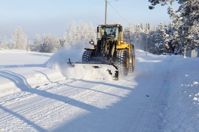 "Forserum, Sweden - December, 26th 2010: Snow removal using a Volvo Wheel Loader after a heavy snowfall."